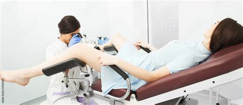 Women Having A Cervix Exam By Her Gynecologist Lying On A Gynecological Chair Colposcopy