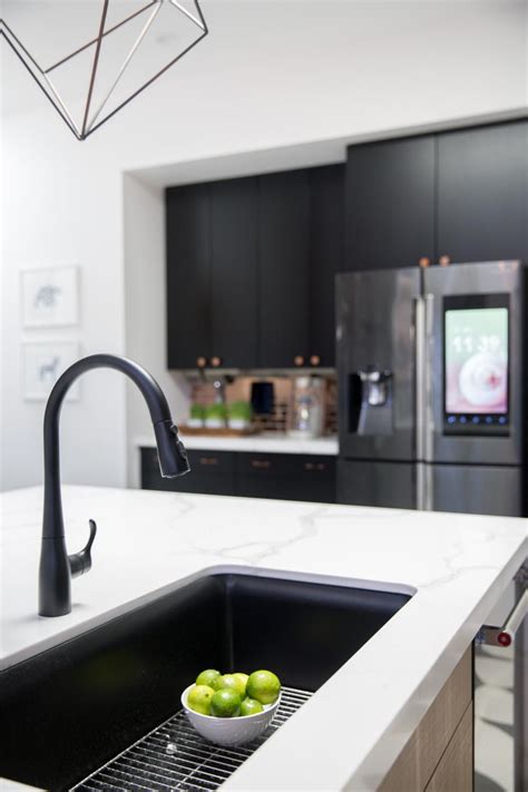 A graphic black and white tile floor, a waterfall quartz topped island