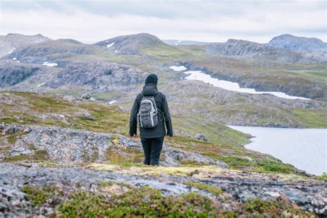 Mature Woman Walks Down Over High Altitude Norwegian Mountains Range