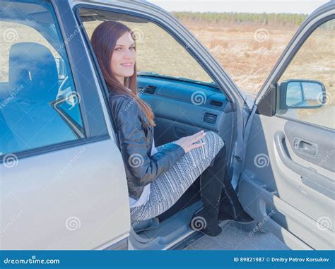 In The Passenger Seat Of The Car An Attractive Girl Stock Image