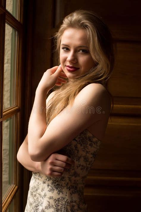 Amazing Blonde Woman With Long Hair Wearing Dress With Naked Shoulders