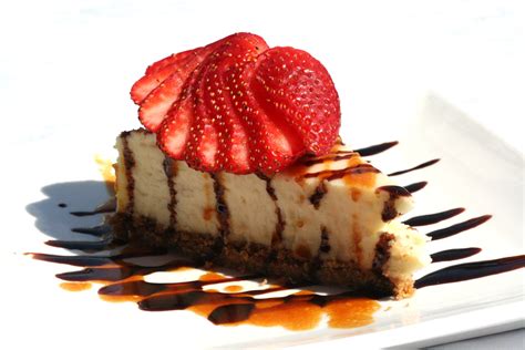 our heavenly new york style cheesecake topped with fresh strawberries drizzled with caramel