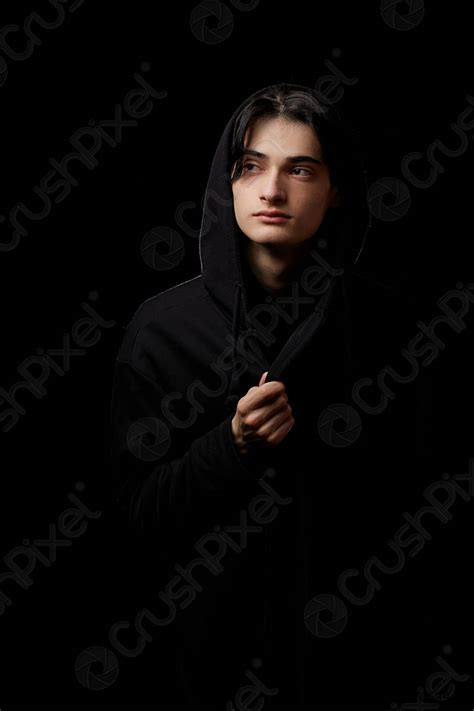 Dramatic Portrait Of A Young Man In Black Clothes On Stock Photo