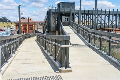 Image Of Access Ramps And An Overhead Walkway At A Regional Railway