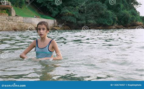 happy teen girl playing in the sea girl happily frolics on the beach stock image image of
