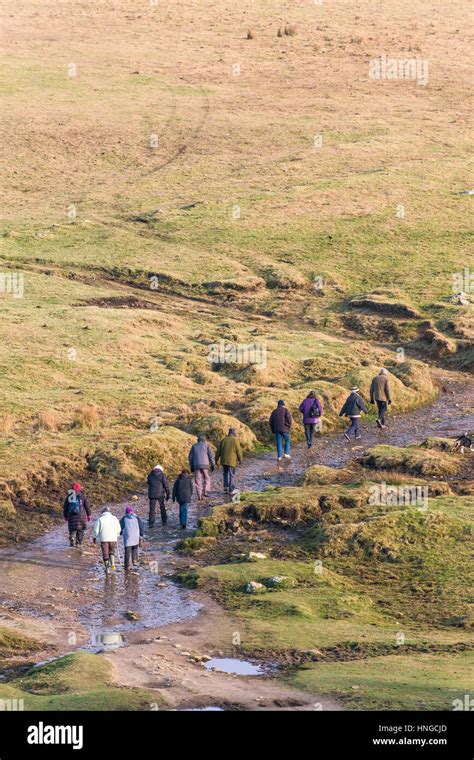 A Group Of Walkers On Rough Tor Designated As An Area Of Outstanding