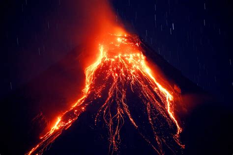 Lava Cascades Down The Slopes Of Mayon Volcano During Its Eruption For