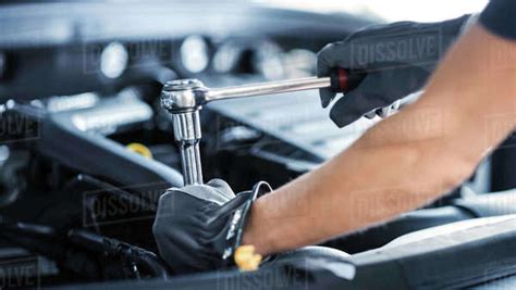 Close Up Shot Of A Professional Mechanic Working On Vehicle In Car