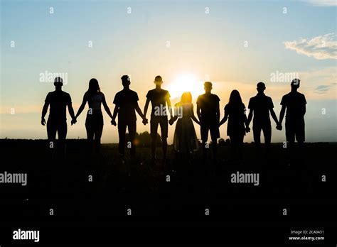 Cohesion Concept Black Silhouettes Of Friends Holding Hands Stands At