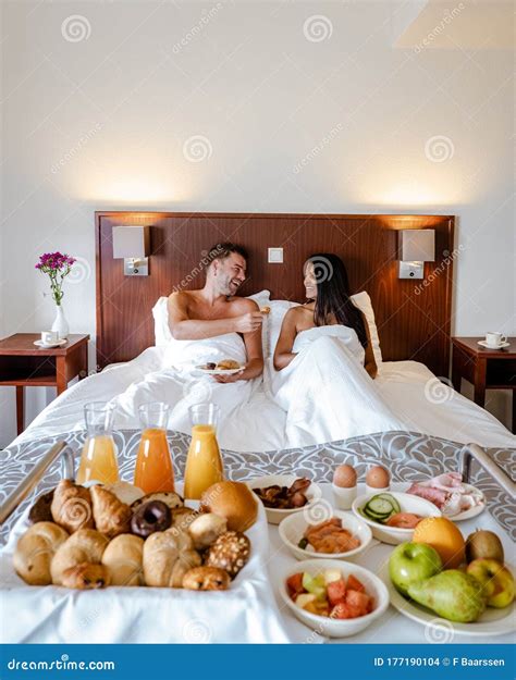 Breakfast In Bed Couple Drinking Coffee In Bed In The Morning At An