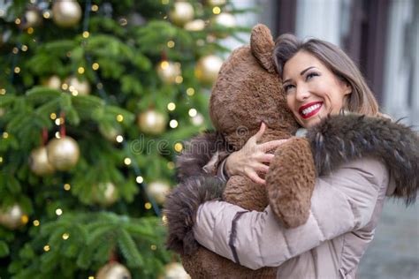 Beautiful Young Woman Hugging A Teddy Bear Present For Christmas Stock