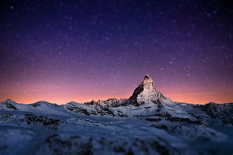 Matterhorn Mountain In The Alps Covered With Snow And Glimmering