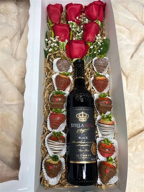 A Bottle Of Wine In A Box With Strawberries And Chocolates On The Side