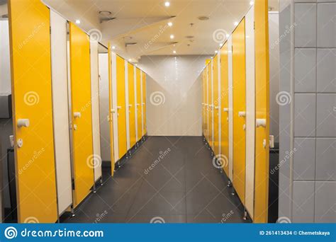 Public Toilet Interior With Bright Yellow Stalls Stock Photo Image Of