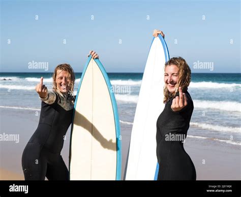 Surfer Females On The Beach Showing Middle Finger Stock Photo Alamy