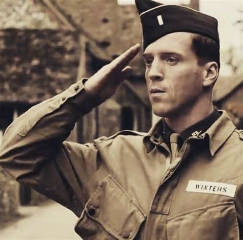 A Man In Uniform Saluting To The Side
