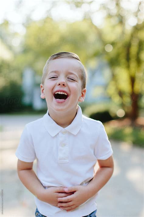 Portrait Of An Adorable Young Boy Laughing By Stocksy Contributor