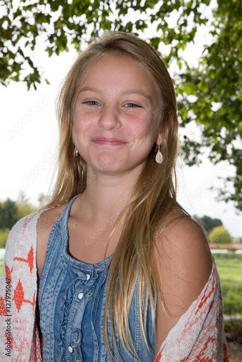 Cute Blonde Teen Girl Smiling In Grass Stock Photo Adobe Stock