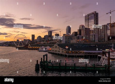 Beautiful Seattle Waterfront Skyline At Dusk With Piers And Skyscrapers