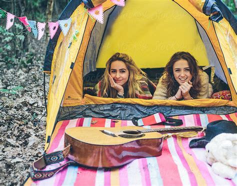 Two Teenage Girls Camping In A Forest By Stocksy Contributor Kkgas