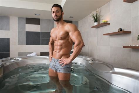 Premium Photo Wellness Spa Man Flexing Muscles In Hot Tub Whirlpool