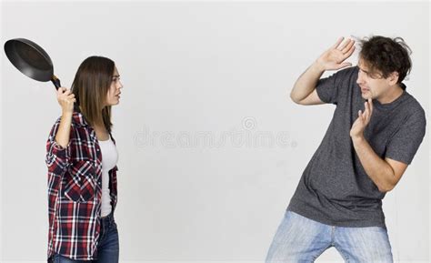Woman With Cooking Pan Being Angry At Her Man Couple Standing A Stock Image Image Of Problems