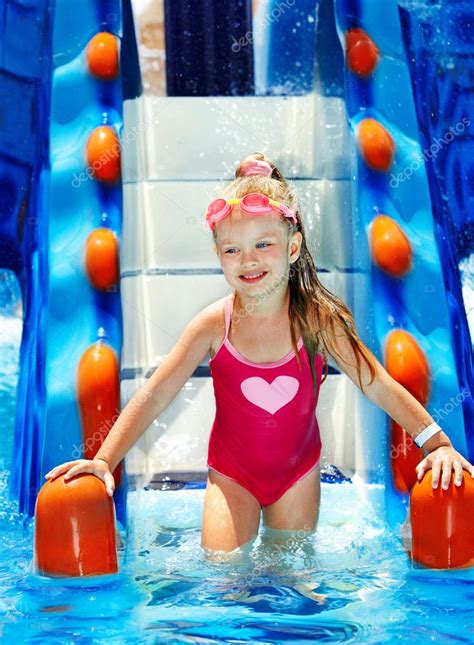 Child On Water Slide At Aquapark — Stock Photo © Poznyakov 10518863