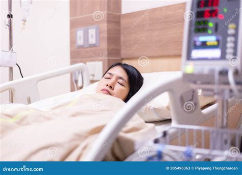 Patient Asian Women Sleeping Under Blanket On Sick Bed At The Hospital
