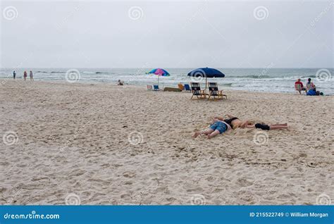 Three Boys With Their Heads In The Sand Editorial Stock Image Image