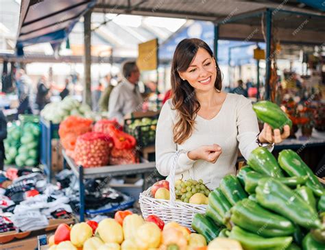 Premium Photo | Young woman at local food market.