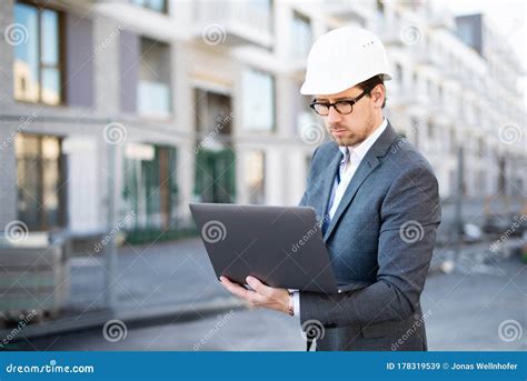 An Architect Civil Engineer At Work On A Construction Site Holding