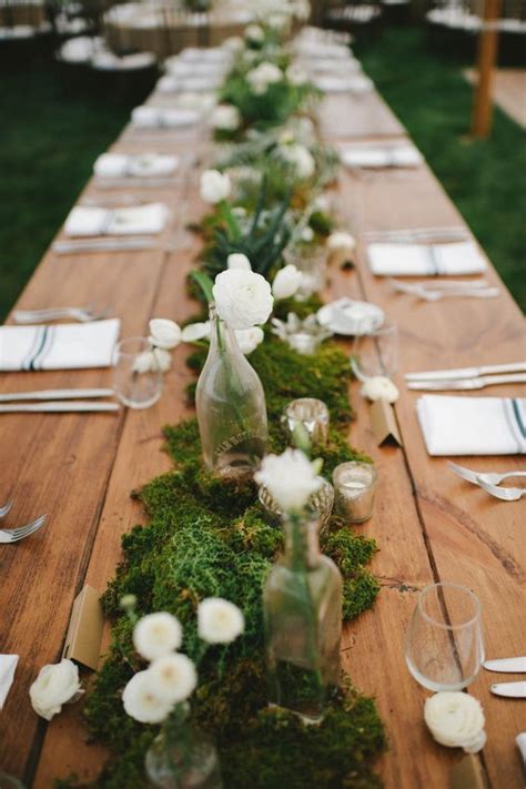 Moss Table Runner Decorated With White Flowers Bottle Vases And