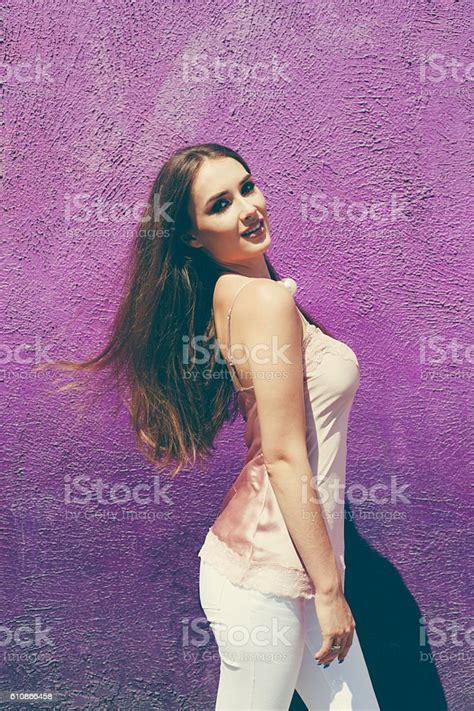 Beautiful Fashionably Dressed Darkhaired Girl Posing Near The Purple