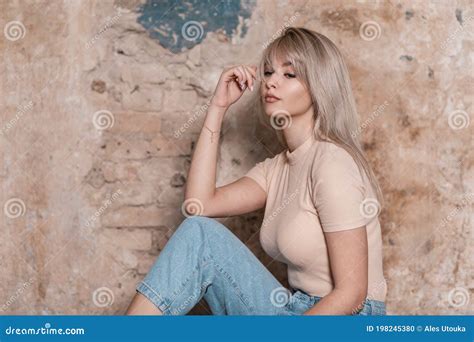 European Sensual Young Woman Blonde In A Stylish T Shirt In Blue Jeans