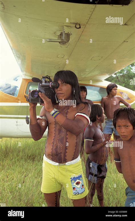A Ukre Village Xingu Brazil Kin Abaiti A Kayapo Man Using A Panasonic Video Camera Under The