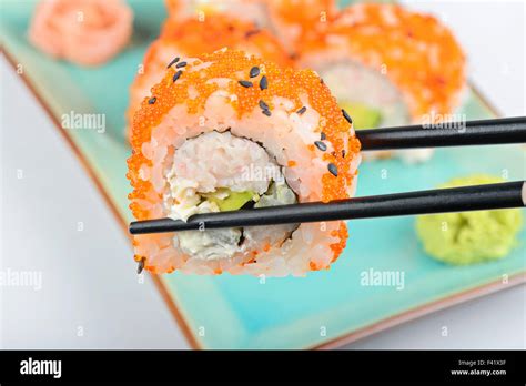 Sushi Roll With Black Chopsticks Stock Photo Alamy