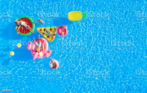 Aerial Group Of Happy Attractive People Hanging Out On Fun Floaties In