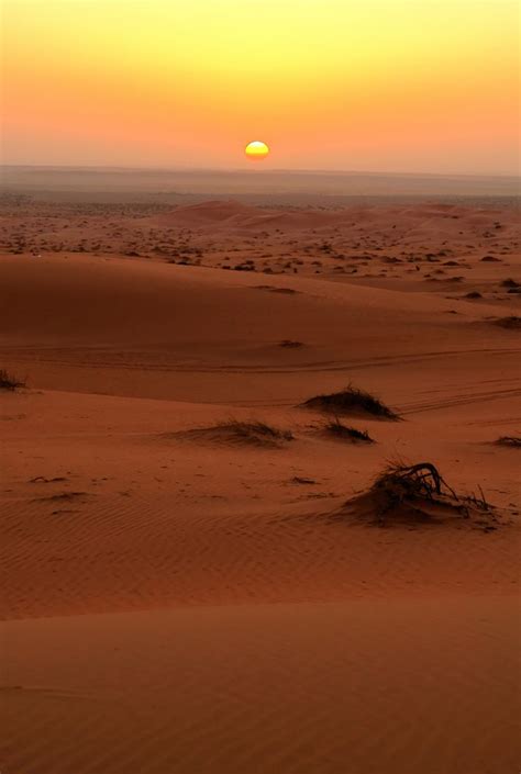 The Sun Is Setting In The Desert With Sand Dunes