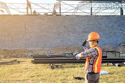 Engineer Technician Watching Team Of Workers On High Steel Platform