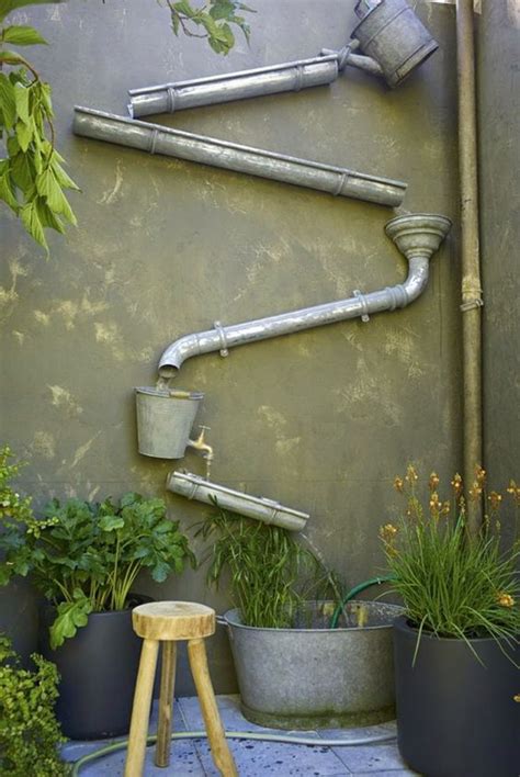 If you love the sound of trickling water, but don't have a ton of space to include an oversized fountain in your garden, a flower pot water feature like this works perfectly in small spaces. 20 Crafty DIY Rain Features For Your Gardens | HomeMydesign