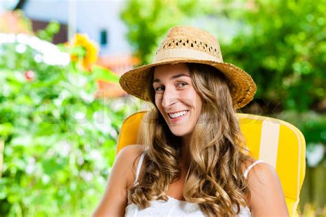 Woman Tanning In Her Garden On Lounge Chair Stock Image Colourbox
