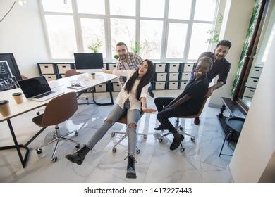 Cheerful Colleagues Having Fun Office Chairs Stock Photo