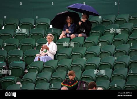 Spectators With Umbrellas On Day Two Of The 2022 Wimbledon