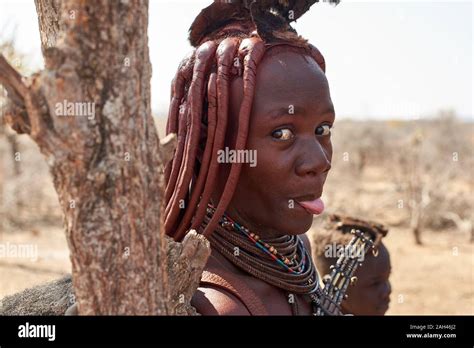 Portrait Of A Himba Woman Sticking Out Tongue Opuwo Namibia Stock