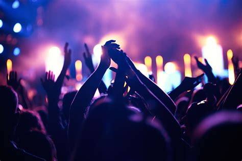 Cheering Crowd With Hands In Air At Music Festival Stock Photo