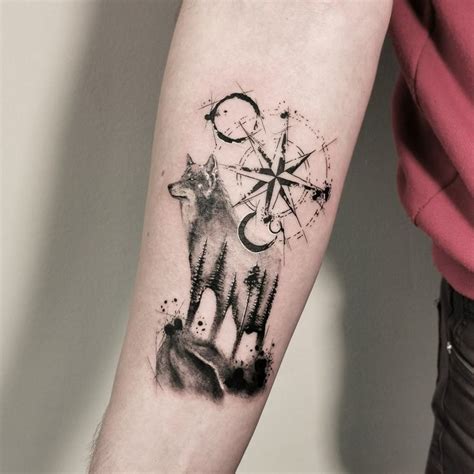 A Person With A Tattoo On Their Arm Has A Wolf And Compass In The Background