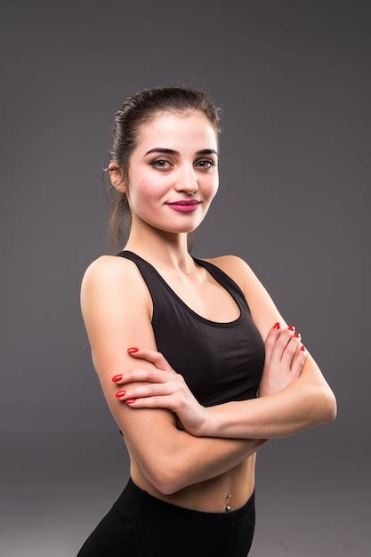 Free Photo Close Up Of Fit Woman S Torso With Her Hands On Hips On Grey Wall