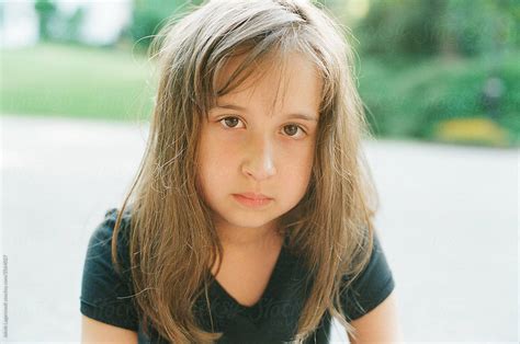 Portrait Of A Young Girl Looking At The Camera Intently By Stocksy