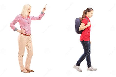 Full Length Portrait Of Angry Mother Yelling At Her Daughter Stock