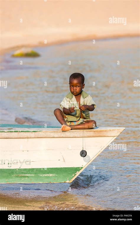 Local African Boy Playing At Fishing From A Fishing Boat Kaya Mawa